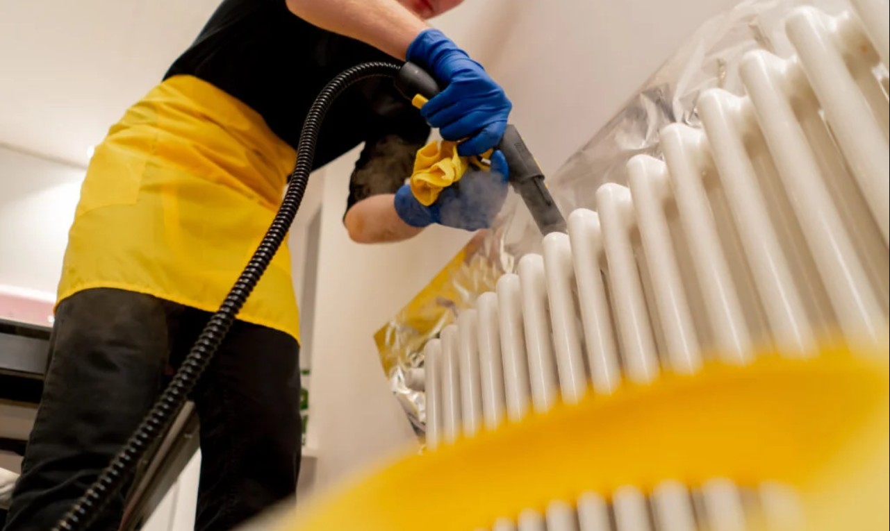 Detailed steam cleaning around a radiator